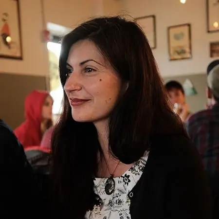 7 author Shoutouts Mona Awad with dark hair in a cafe