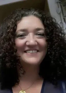 Author Shoutout 7 Author Shoutouts Jeannie Wycherley with curly hair and necklace
