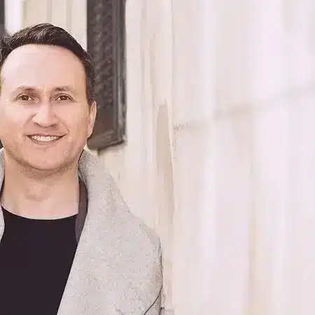 Author Shoutout 7 Author Shoutouts John Marrs standing against a wall near a window