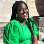 An Arcane Inheritance by Kamilah Cole a woman in green outfit outdoors.