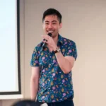 City of Others author Jared Poon speaking at a presentation event.