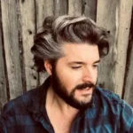 Adrift author Will Dean with wavy hair, plaid shirt.