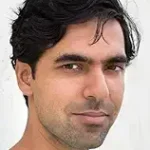 The Complex author Karan Mahajan with dark, wavy hair.