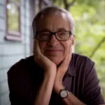 The Marriage Bed author Tommy Hays sitting with hands on face.