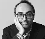 Little Failure author Gary Shteyngart black & white portrait with his hand on his cheek