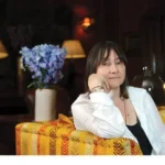 Glyph author Ali Smith sitting on colorful sofa
