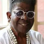 Bridging the Rivers of Difference author Catherine Meeks with glasses and pearls