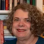Lammie Loves Cubby author Nora Gaskin smiling with curly hair