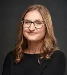 Appraisals author Claire Boyles with glasses and wavy hair