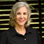 Invasive Species author Ellery Adams smiling with gray hair