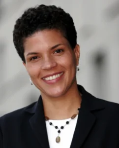 Author Shoutout author shoutouts Michelle Alexander smiling in professional attire.
