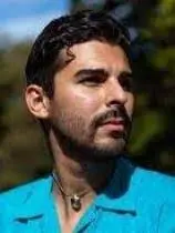 CrocoDilopolis Crocodilopolis author John Manuel Arias with dark hair in turquoise shirt
