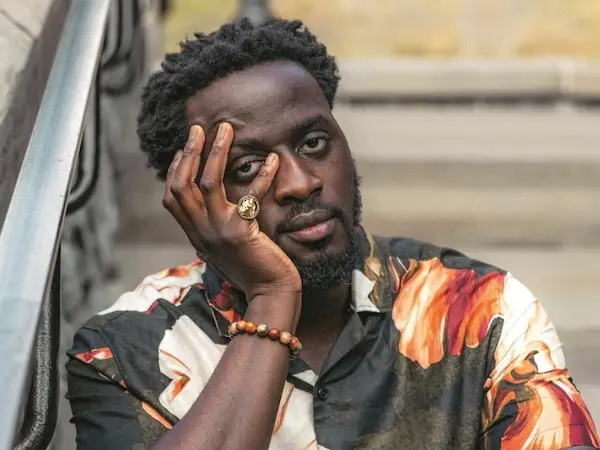 Author Shoutout Author Shoutout Nana Kwame Adjei-Brenyah resting hand on face thoughtfully