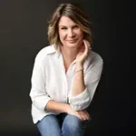 Memory of Borrowed Books The Memory of Borrowed Books author Meg Anderson sitting, smiling, casual attire.