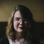 Milkteeth Milkteeth author Caitlin Starling with glasses and wavy hair