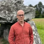 Pan Pan author Francesco Dimitri in front of stone structure