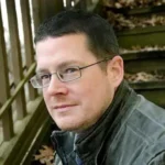 Red Rabbit Red Rabbit author Alex Grecian with glasses on stairs
